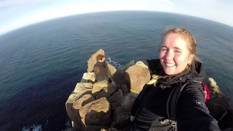 Couple above Dolerite columns of Cape Raoul Stock Footage 71941890