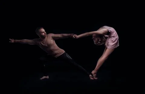 Couple of adagio performs an element in the back bend. a girl in a pink dres Stock Photos