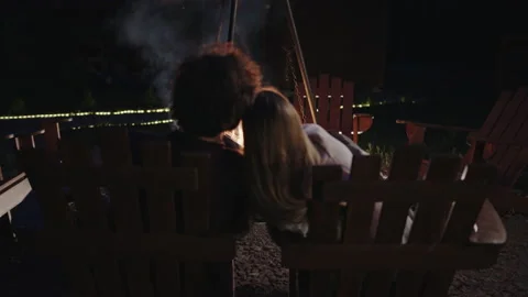 Couple admiring bonfire in backyard 動画素材 219952371