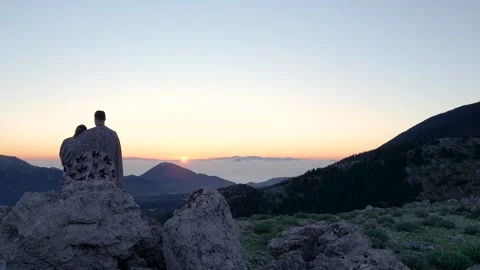 Couple admiring setting sun over mountains Stock Footage 289139560