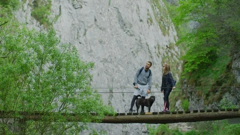 Couple admiring the view from a bridge Stock Footage 99963335