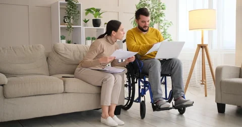 Couple analyzing documents and using laptop at home Stock Footage 145211896