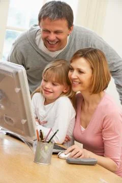 Couple And Daughter Using Computer Stock Photos