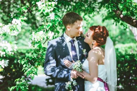 The couple in the Apple trees, looking at each other, a flowering white tree Stock Photos
