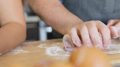 Couple in aprons kneading beet read pasta dough Stock Footage 199152751