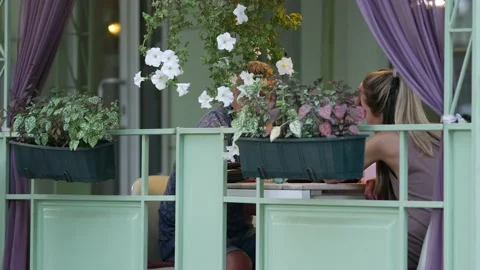 Couple are having dinner in evening. Man and woman are chatting at cafe table Stock Footage 158897584
