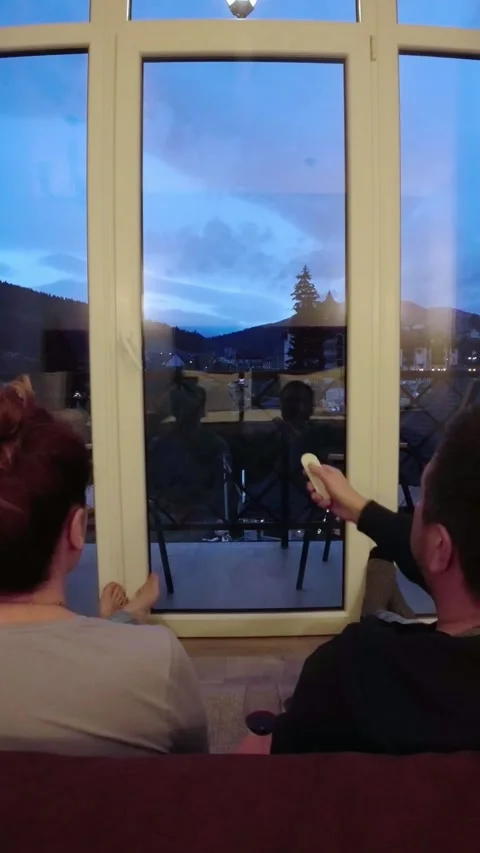Couple are sitting in front of the balcony window in hotel room and look at.. Stock-Footage 257555050