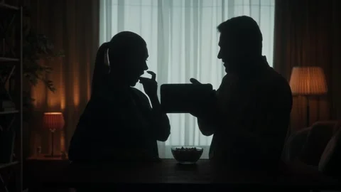 A couple are standing at the table watching a photo, video, film on a tablet 스톡 동영상 245460688