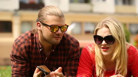 Couple arguing with each other while lying on the grass Video stock 77475427