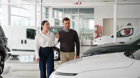 Couple arguing while choosing a new car at dealership Stock Footage 303383765