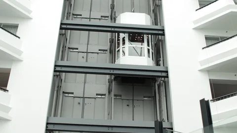 Couple on Ascending White Elevator Corporate Stock Footage 92696066