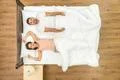 The couple awake on the bed. View from above Photo