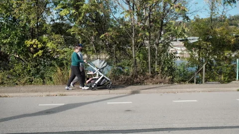 Couple with baby stroller Stock Footage 253124352