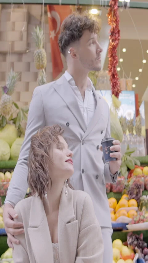 Couple on background of bazaar. Action. Elegant couple are standing on Stock Footage 285710655
