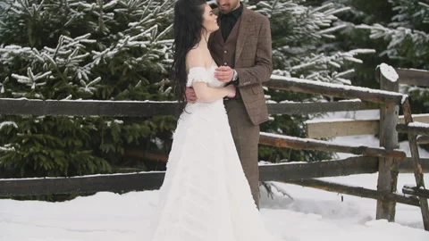 Couple on the background of a snowy forest Stock Footage 147685034
