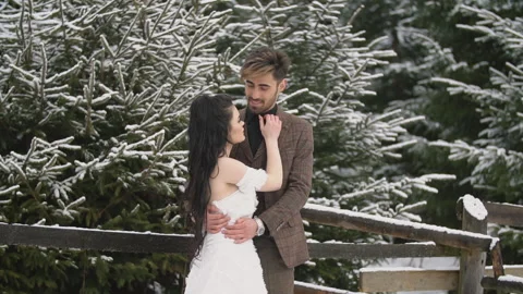Couple on the background of a snowy forest Stock Footage 147730467