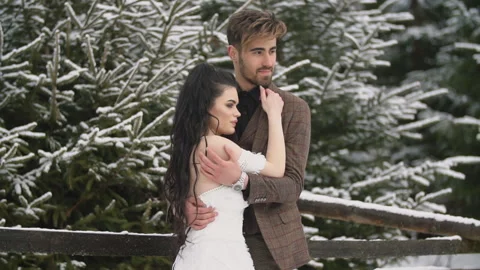 Couple on the background of a snowy forest Stock Footage 148266233