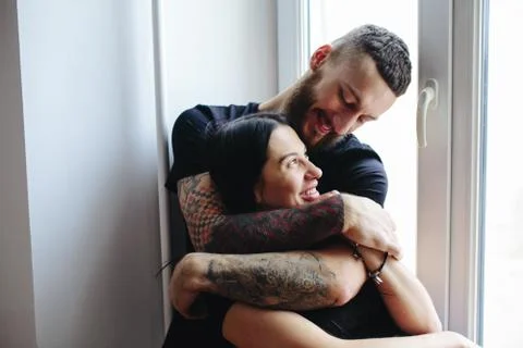 Couple on the background of a window Stock Photos