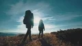 The couple with backpacks walking to the mountain. slow motion 4k or 4k+ Resolution