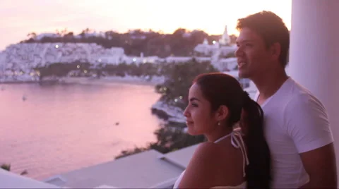 Couple on balcony looking at sunset Stock Footage 1092273