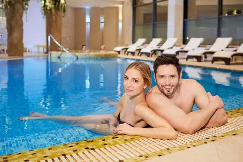 Couple in bathing suits in the pool resting spa center Stock Photos