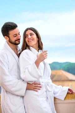 Couple in bathrobe standing on hotel balcony. Stock Photos