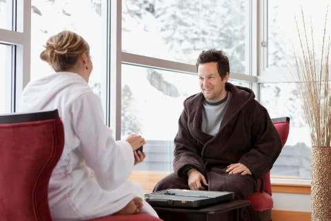 Couple in Bathrobes Playing Backgammon Stock Photos