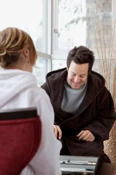Couple in Bathrobes Playing Backgammon Stock Photos