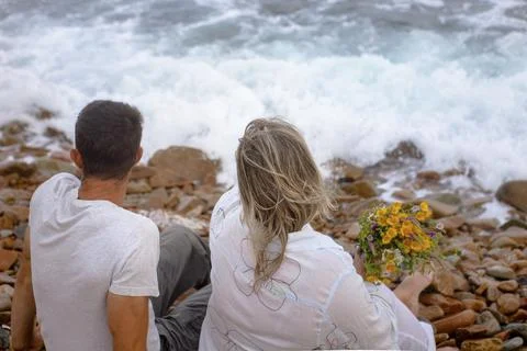 Couple on the beach from the back Stock Photos