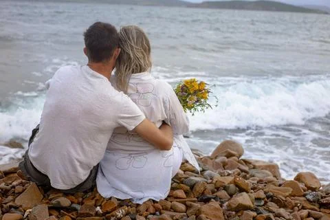 Couple on the beach from the back Stock Photos