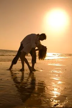 A couple at the beach dancing Stock Photos
