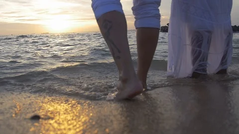 Couple on the beach during sunset Stock Footage 128074515