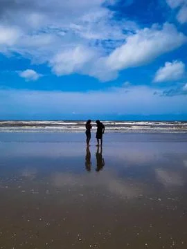 Couple at the Beach at Dusk Stock Photos