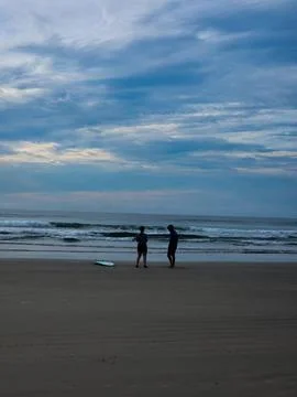 Couple on the Beach at Dusk Stock Photos
