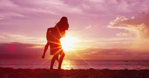 Couple on beach having fun happy doing piggyback enjoying sunset on travel Stock Footage 85454107
