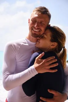 Couple on a beach hugging Stock Photos