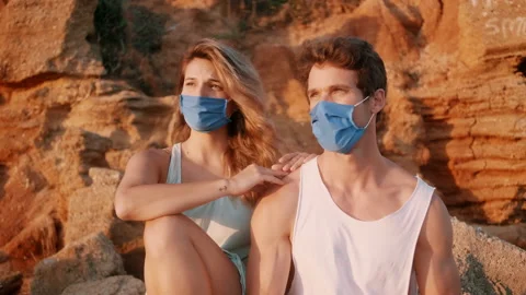 Couple On The Beach Removing Protective Face Mask Stock Footage 136597831