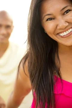 Couple on the beach smiling. Stock Photos