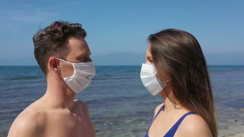 Couple on Beach with Sunburn in Shape of Face Mask Video stock 142879742