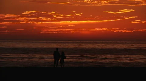 A couple on the beach at sunset Stock Footage 1091652