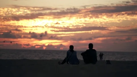 Couple on beach at sunset in Los Angeles Stock Footage