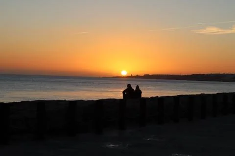 Couple at the beach on sunset Stock Photos