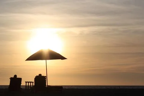 Couple on the beach at sunset 写真素材