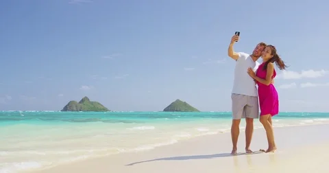 Couple on beach vacation taking selfie smart phone Stock Footage 85036233