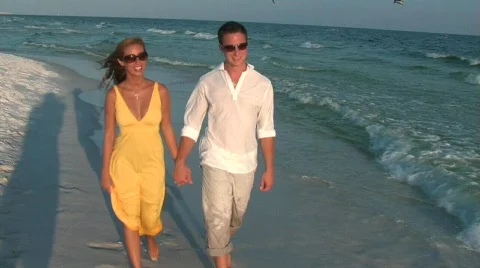 Couple beach walk handheld Stock Footage 299373