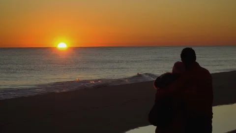 A couple in the beach watching the sunset Stock Footage 100671203