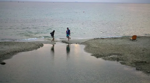 A couple in a beach where the river flows into the sea Video stock 67900429