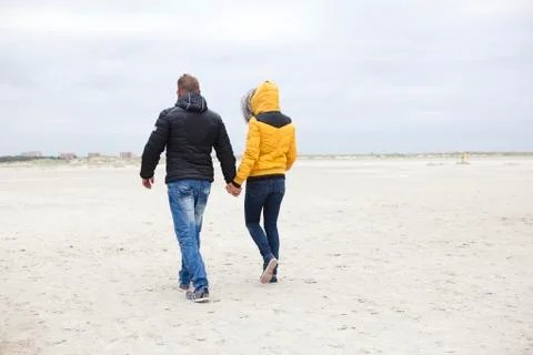 Couple at the beach in winter Stock Photos