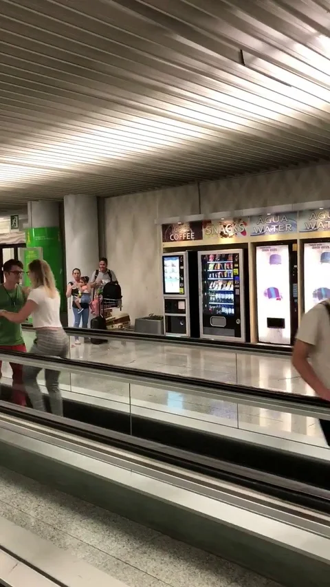 Couple beats flight delay with impromptu salsa performance on airport walkway Stock Footage 106307087