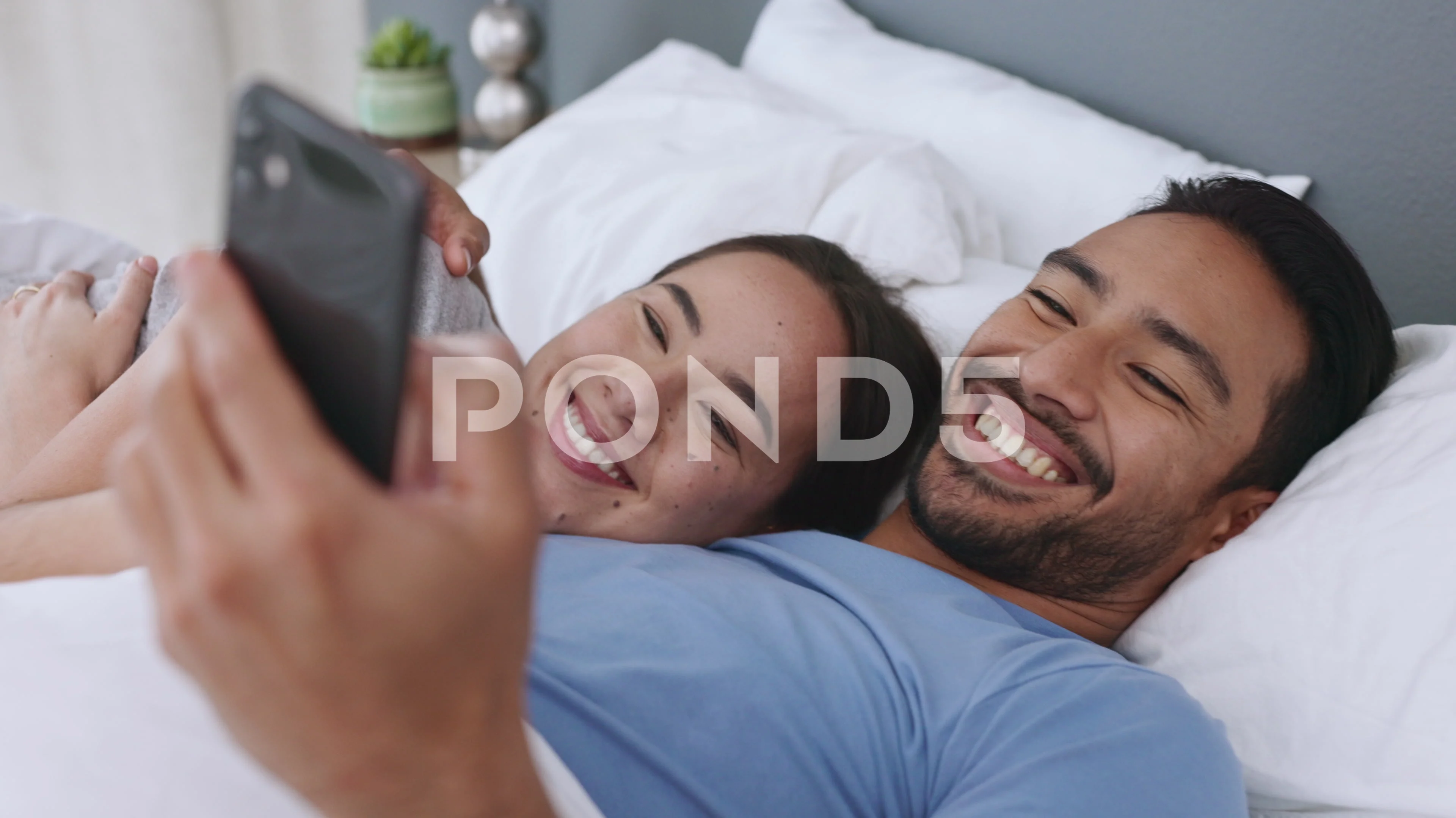 Couple in bed with smartphone for meme, social media online content or